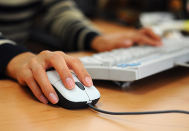 Person using a mouse at a computer